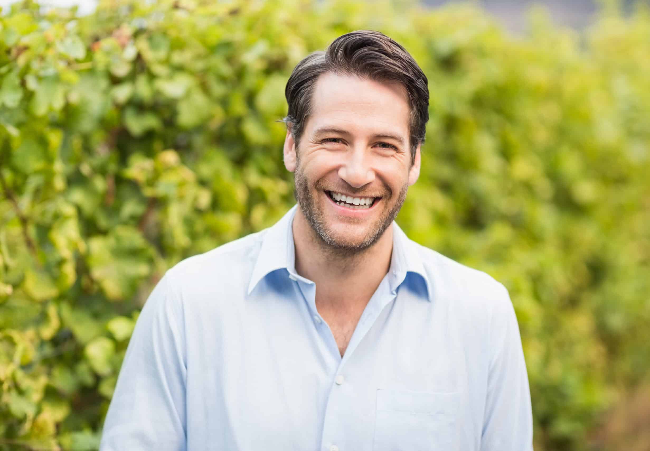 Young,Happy,Man,Smiling,At,Camera,In,The,Grape,Fields